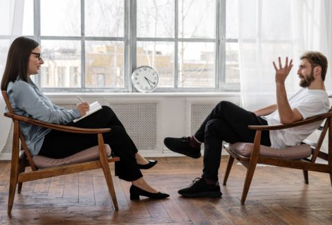 clinician client patient talking in chairs