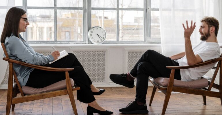 clinician client patient talking in chairs