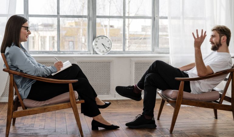 clinician client patient talking in chairs