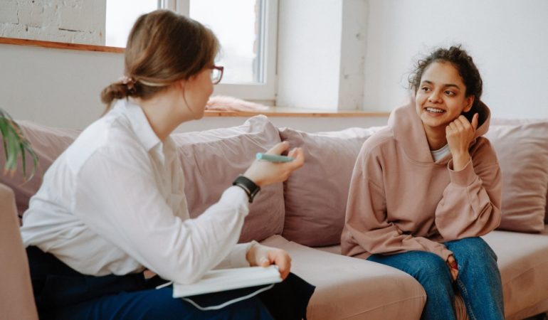 clinician client talking smiling staff couch woman