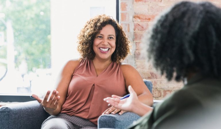 woman clinician client talking smiling happy joy