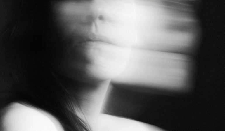 black and white blurred face woman