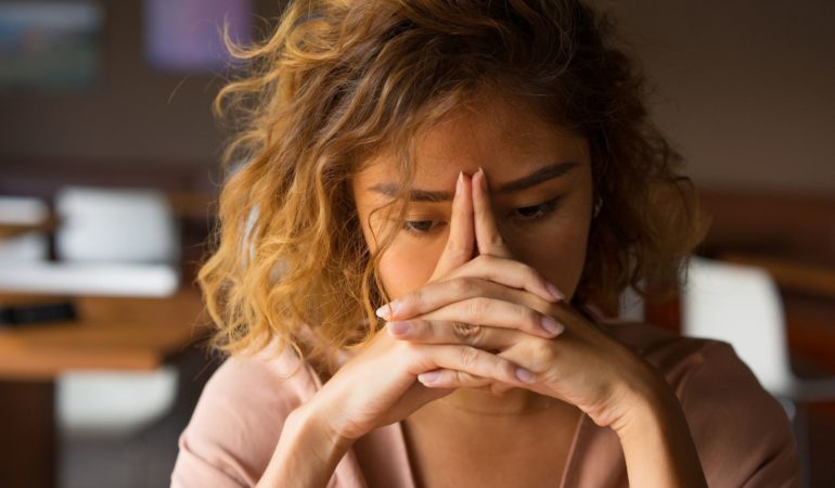 woman fingers thoughtful