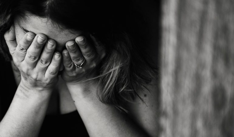 woman holding face black and white