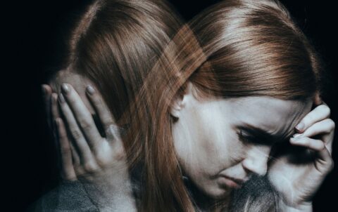 woman holding head upset