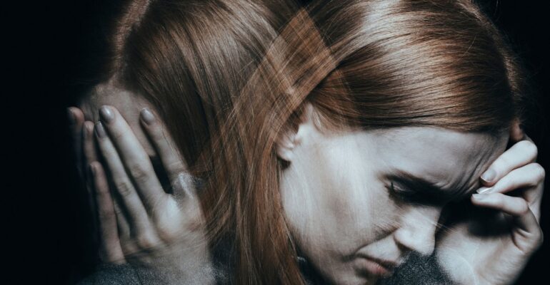 woman holding head upset