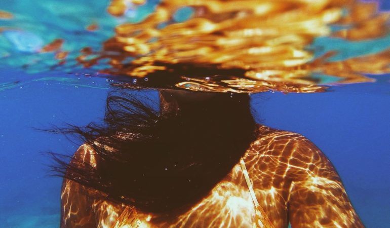 woman underwater pool