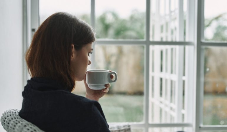 coffee tea sipping woman window