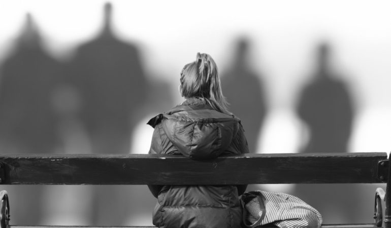 woman seated bench shadows black and white people