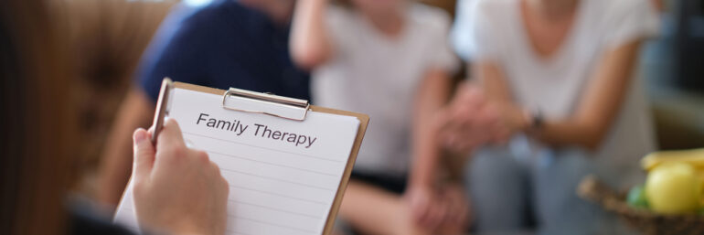 Psychologist at psychotherapy session with family in office