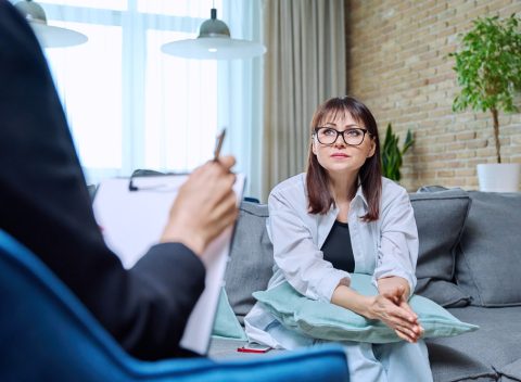 Middle-aged woman at meeting with psychologist, counselor