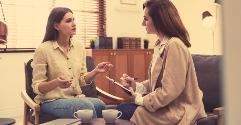 Professional psychotherapist working with patient in office