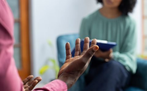 Midsection of african american male patient attending therapy with biracial female therapist. Mental health, therapy and counselling.