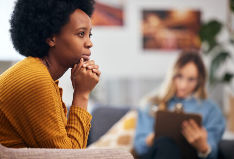 Mental health, anxiety and psychology with a black woman in therapy, talking to a professional. Depression, stress or support with a young patient in session with a psychologist for grief counseling