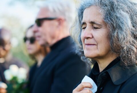 Mature crying woman with tears on her cheek lamenting her relative