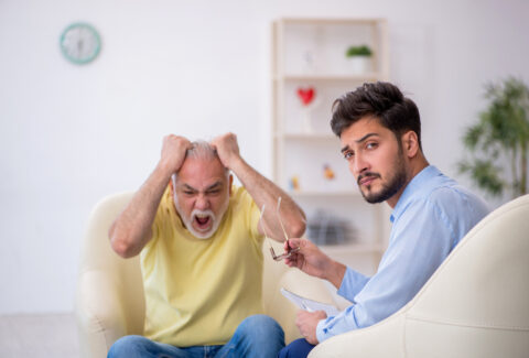 Old man visiting young male psychotherapist