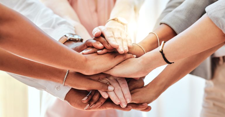 Teamwork, community and support with hands of business people together for collaboration, networking and goals. Mission, team building and motivation with employees for vision, diversity and growth